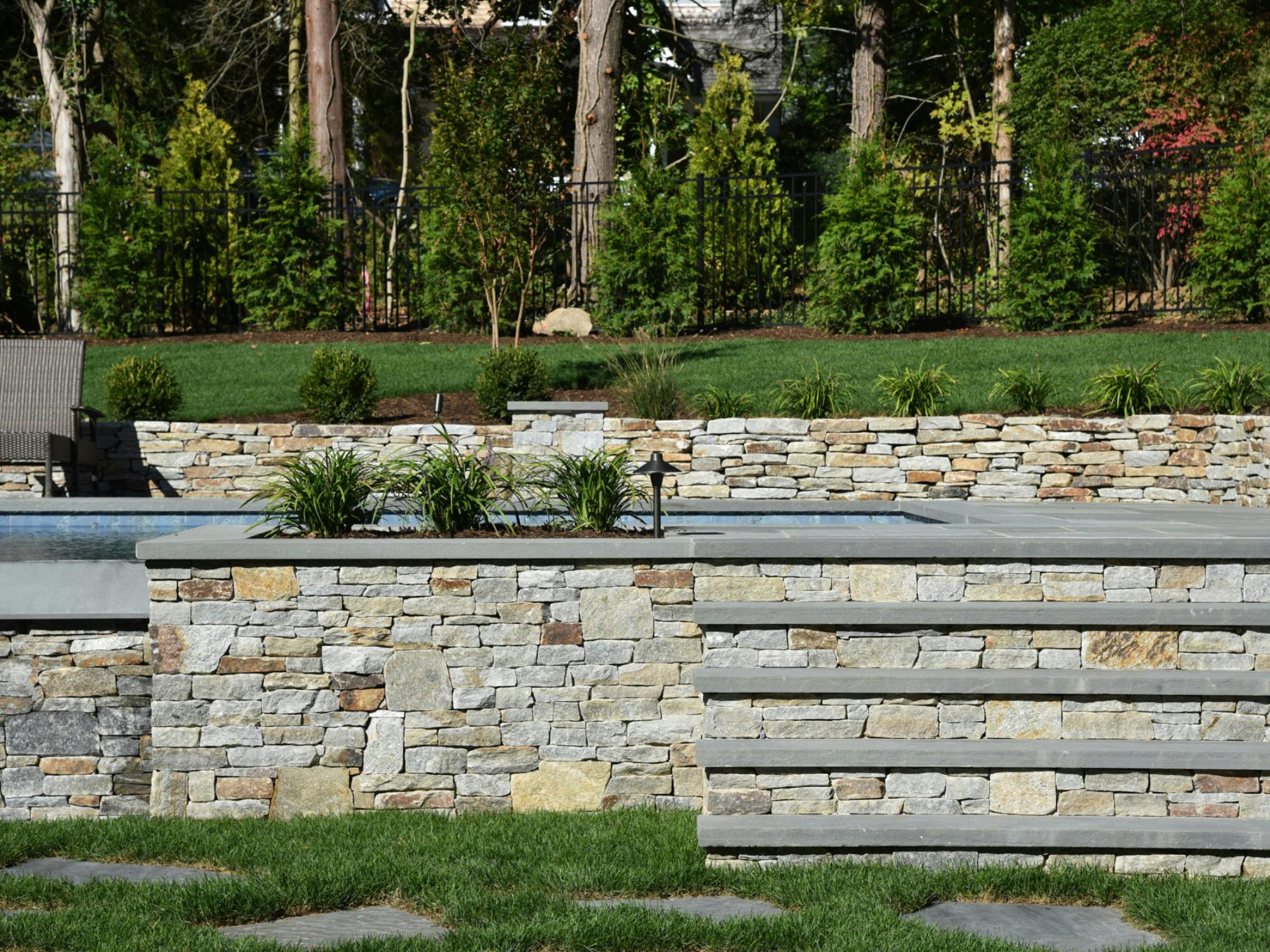 Enhancing Outdoor Elegance: A Natural Stone Swimming Pool & Patio Oasis in Huntington Bay, Long Island.